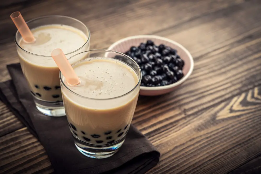 Homemade Milk Bubble Tea with Tapioca Pearls on wooden background