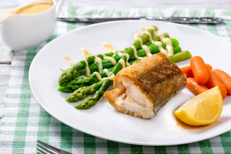 delicious hake  baked in oven and served with asparagus, a lemon