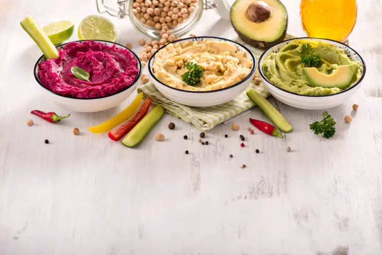 Colorful hummus, different dips, vegan snack, beetroot and avoca