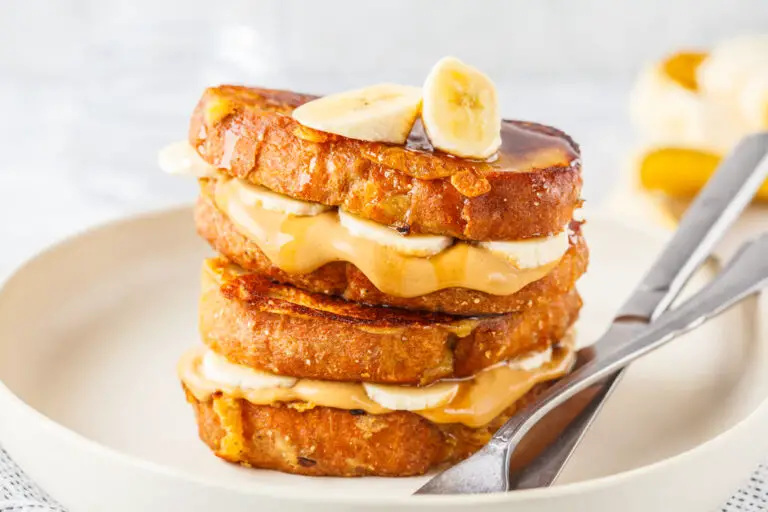 French toasts with peanut butter and banana on a white plate