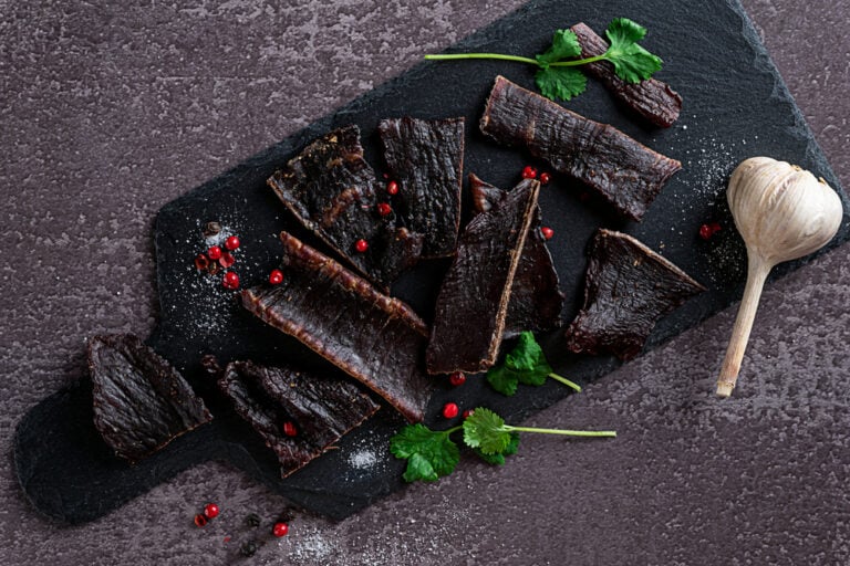 Slices of jerky meat on a dark backdround